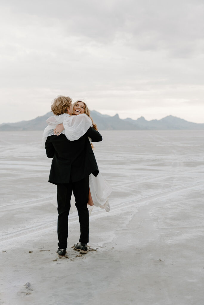 playful bride and groom at bonneville salt flats