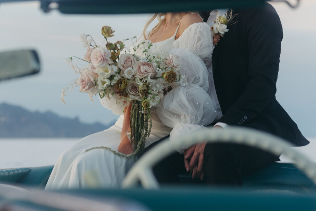 bride and groom sitting in a vintage car