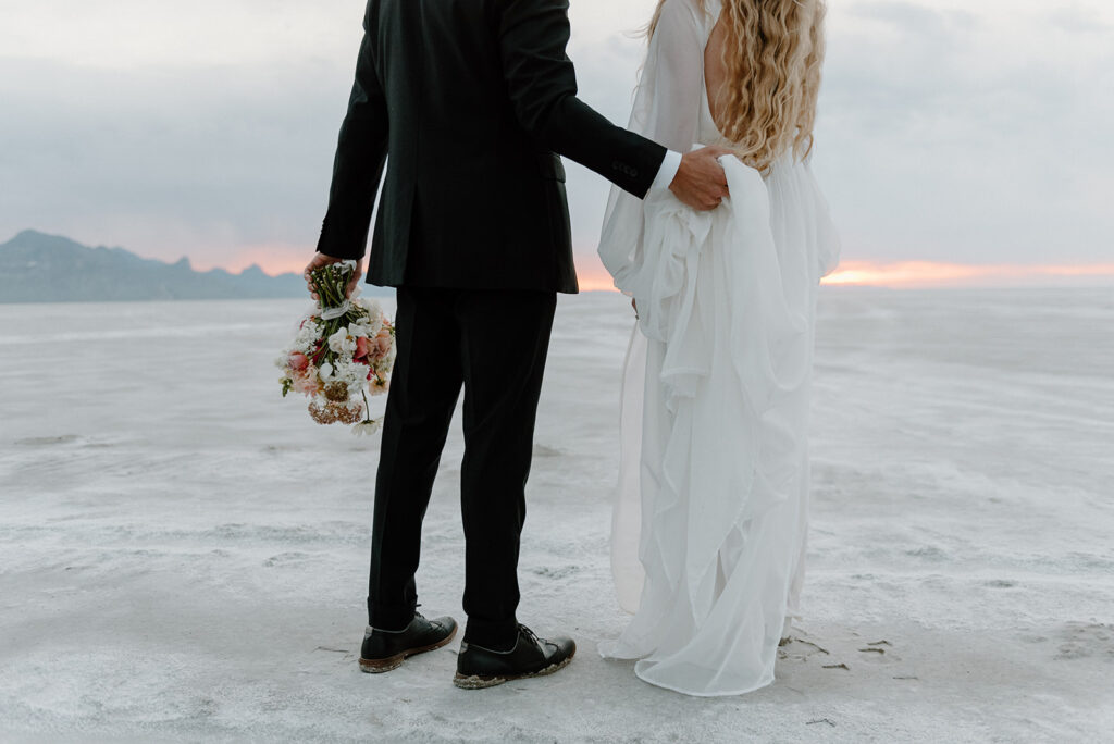 close up of the elopement couple attire with salt flats in the backdrop