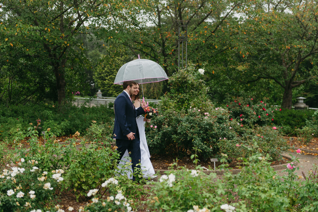 rainy Lewis Ginter Botanical Garden Elopement, couple walking under a clear umbrella