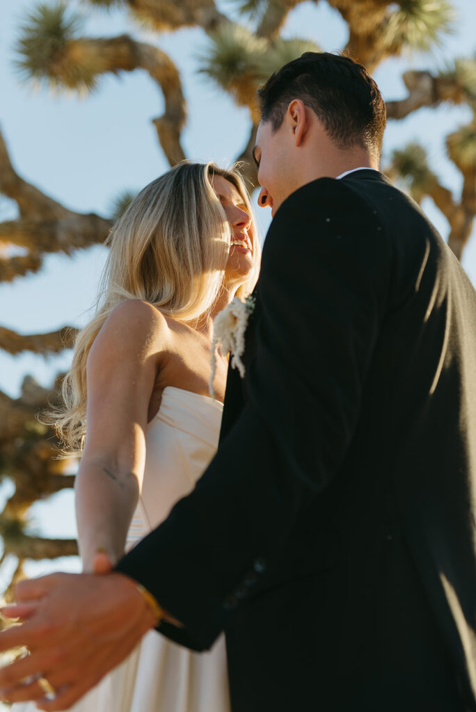 romantic elopement couple with a groovy joshua tree in the background