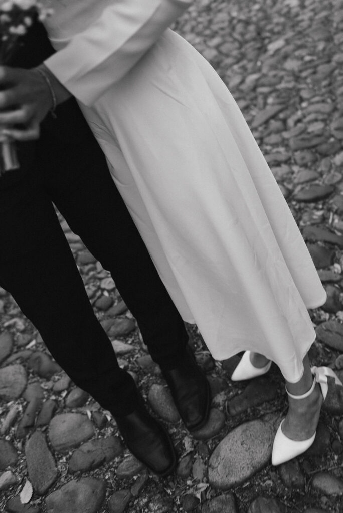 elegant elopement couple standing on a cobblestone street during their winter old town alexandria wedding elopement