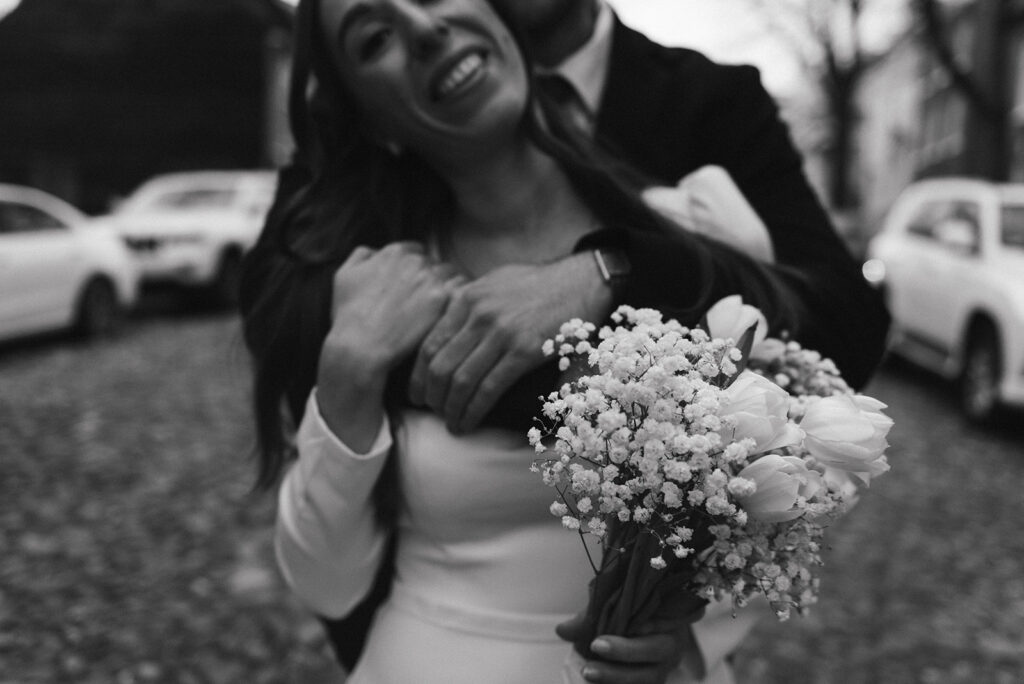 elegant elopement couple standing on a cobblestone street during their winter old town alexandria wedding elopement