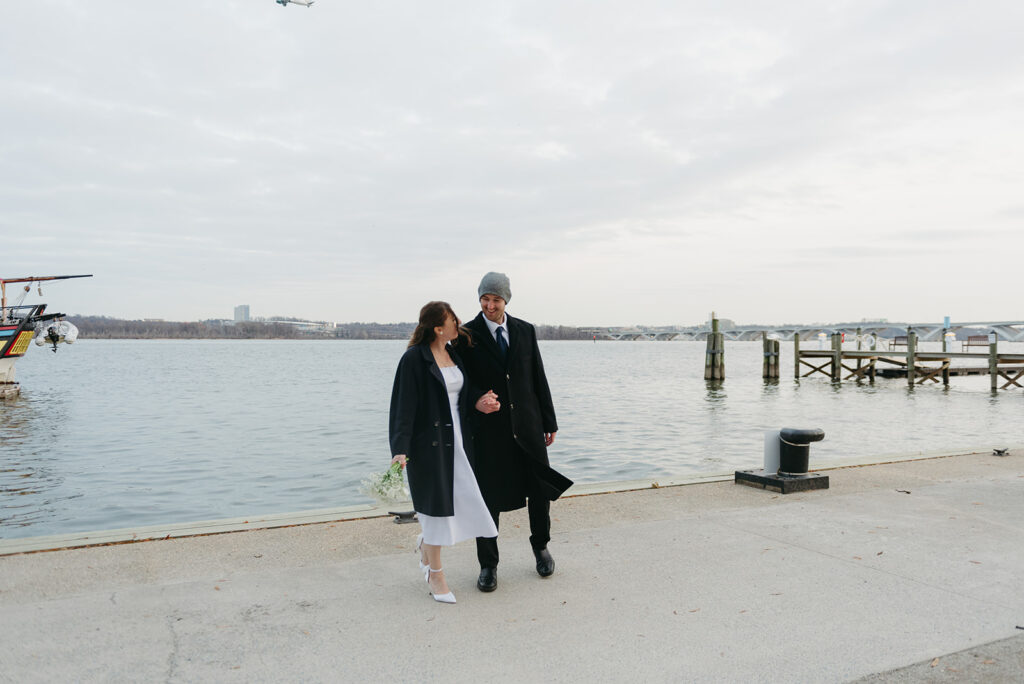 playful elopement couple at the waterfront during their old town alexandria wedding day