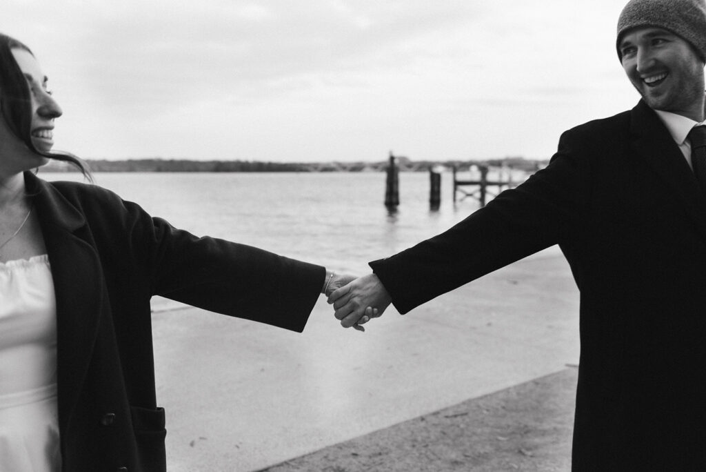 playful elopement couple at the waterfront during their old town alexandria wedding day