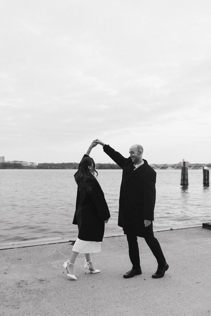 playful elopement couple at the waterfront during their old town alexandria wedding day