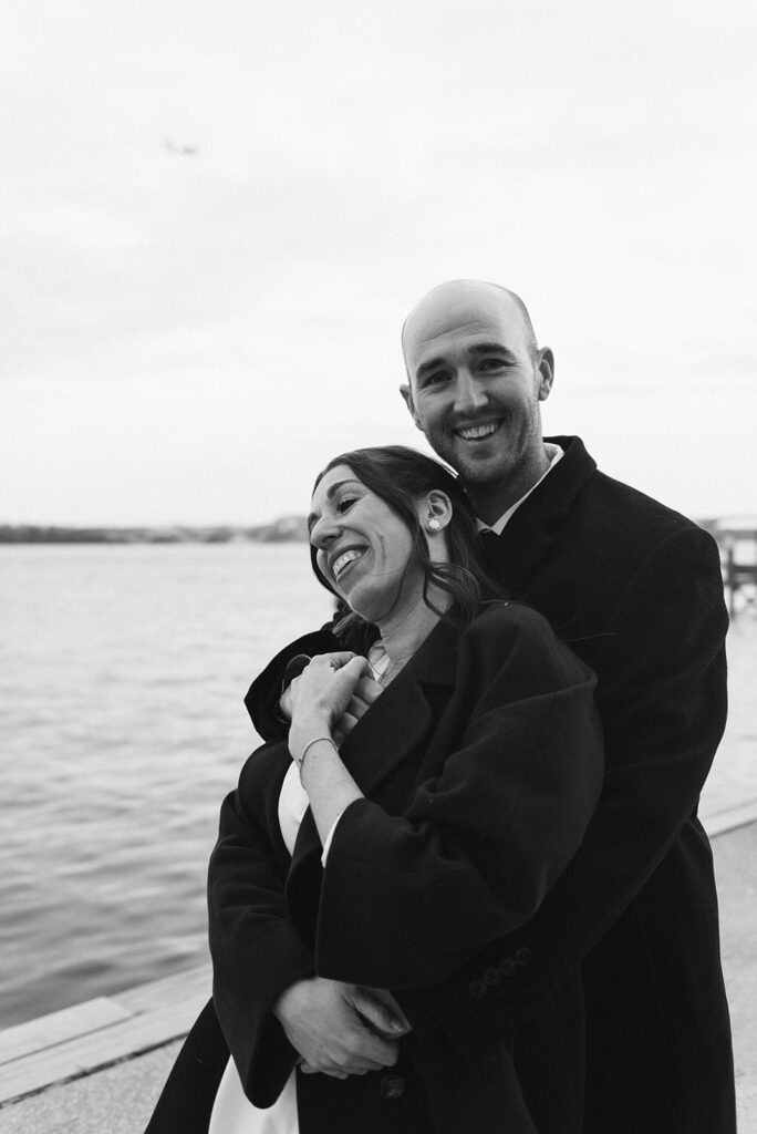 playful elopement couple at the waterfront during their old town alexandria wedding day