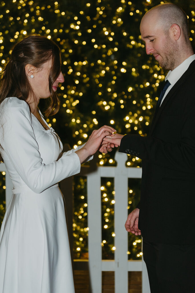 winter elopement ceremony at old town alexandria town square with christmas tree in the background