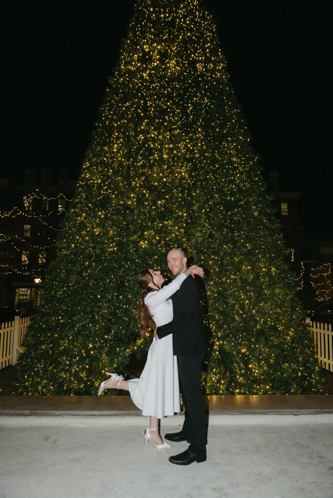 winter elopement ceremony at old town alexandria town square with christmas tree in the background