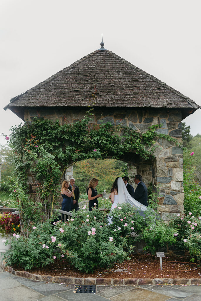 lewis ginter elopement ceremony under a stone gazebo during a bit of rain