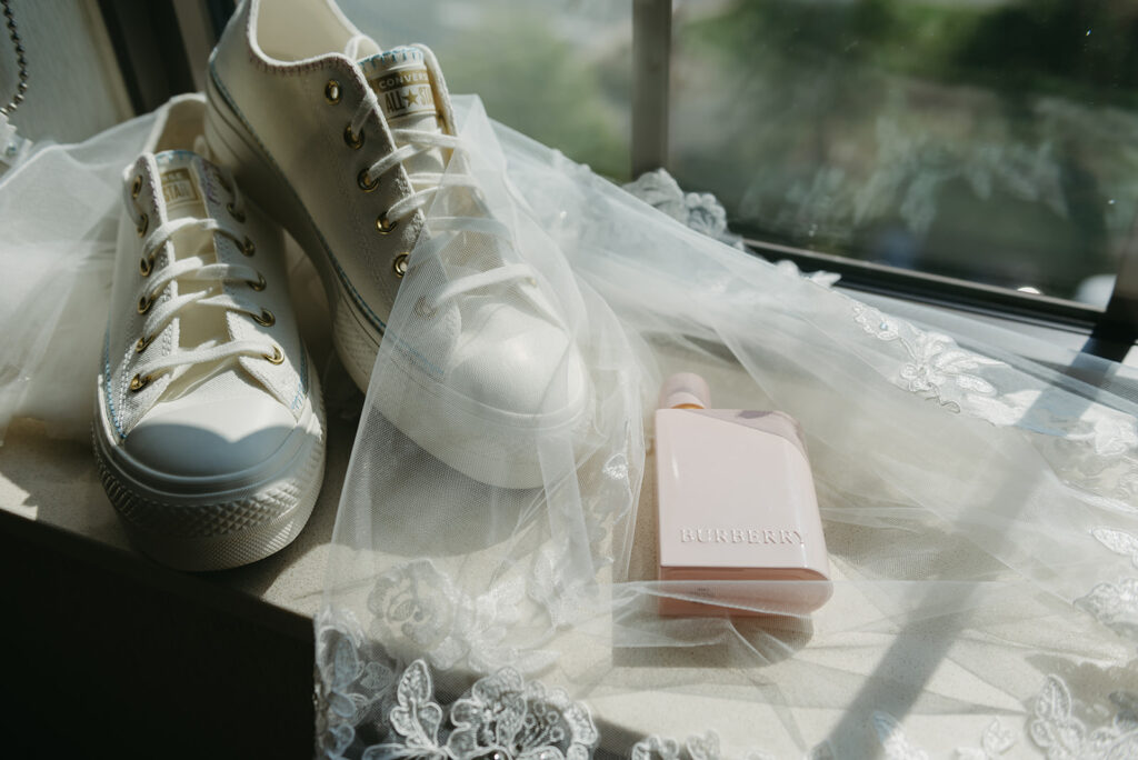 elopement day details of white sneakers and bridal veil