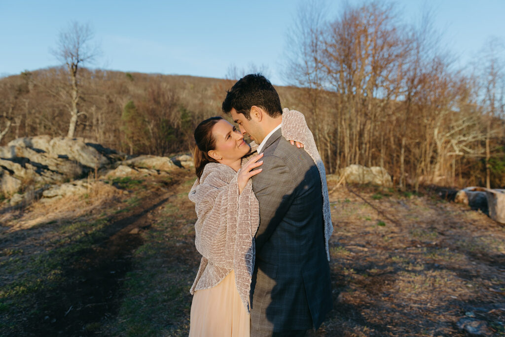snuggly elopement couple under a blanket during their outdoor adventure elopement day in shenandoah national park 
