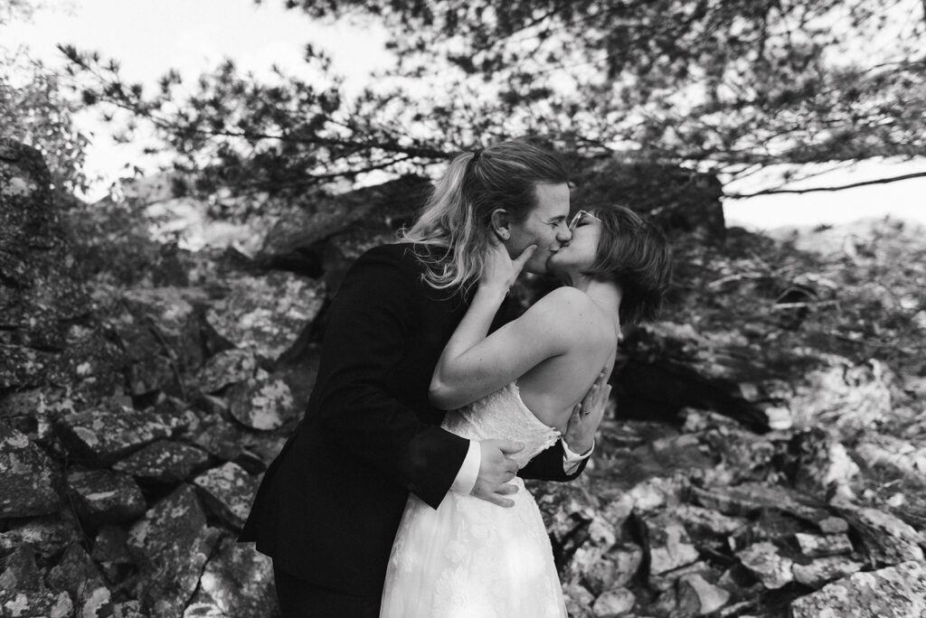 black and white photo of bride and groom kissing during their shenandoah national park elopement near thornton gap