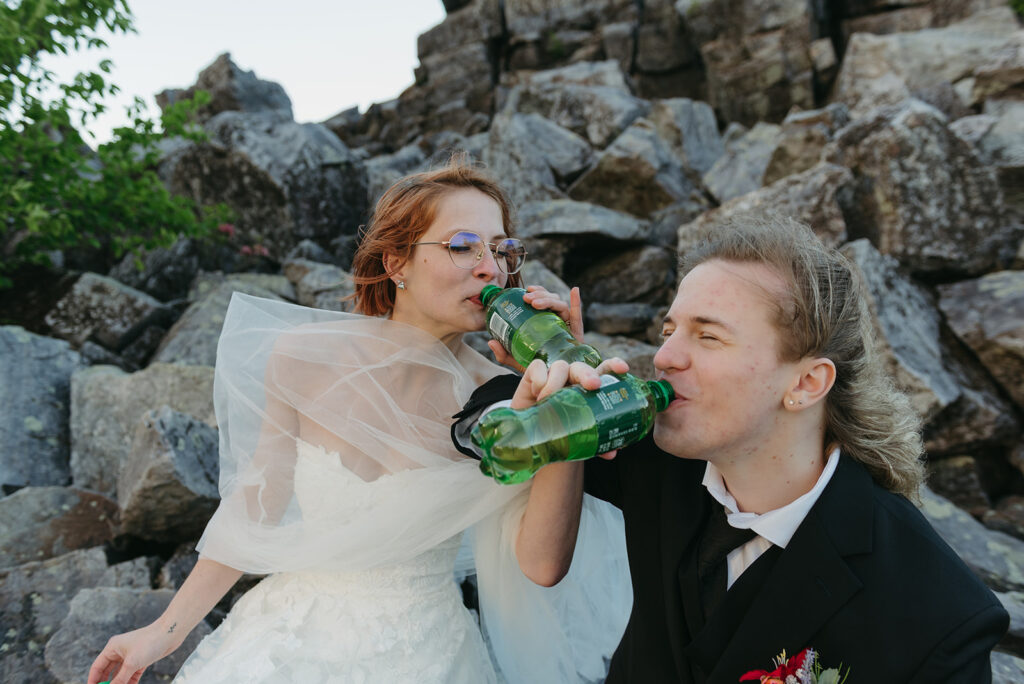 bride and groom drinking sodas together during their shenandoah national park elopement near thornton gap entrance